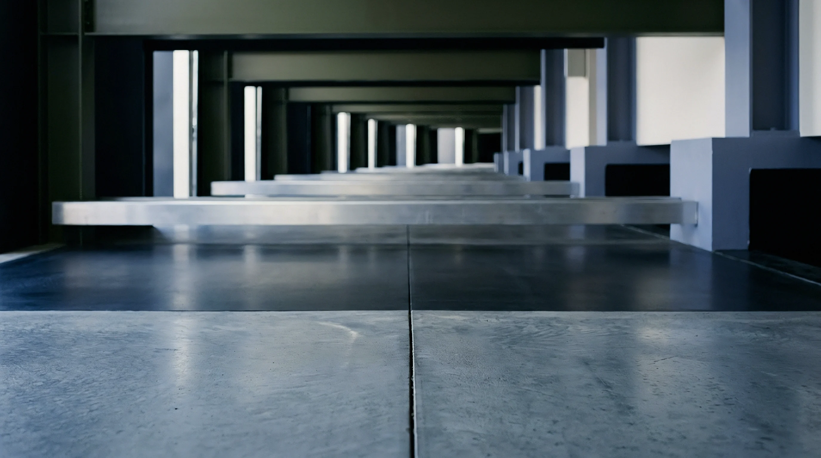 Concrete floors and repeating steel support columns define this perspective view of a modular industrial facility designed for heavy manufacturing and warehouse logistics operations.